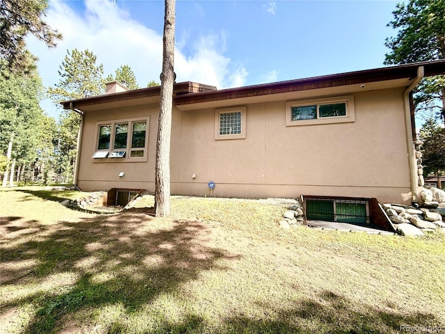 185 Wildrose Ct, Woodland Park, CO 80863 - rear view of property featuring stucco siding