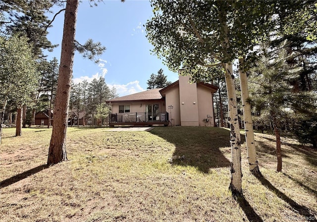 185 Wildrose Ct, Woodland Park, CO 80863 - view of grassy yard with a deck