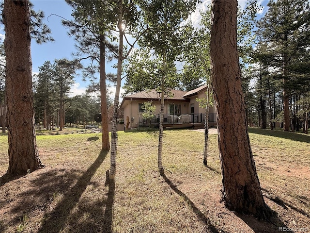 185 Wildrose Ct, Woodland Park, CO 80863 - view of green lawn with a deck