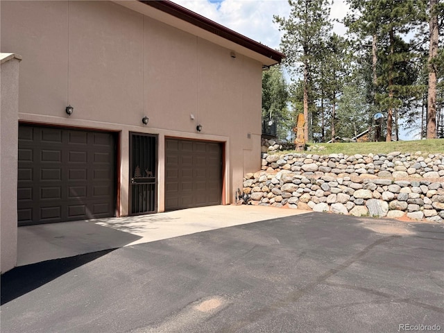 185 Wildrose Ct, Woodland Park, CO 80863 - garage with concrete driveway
