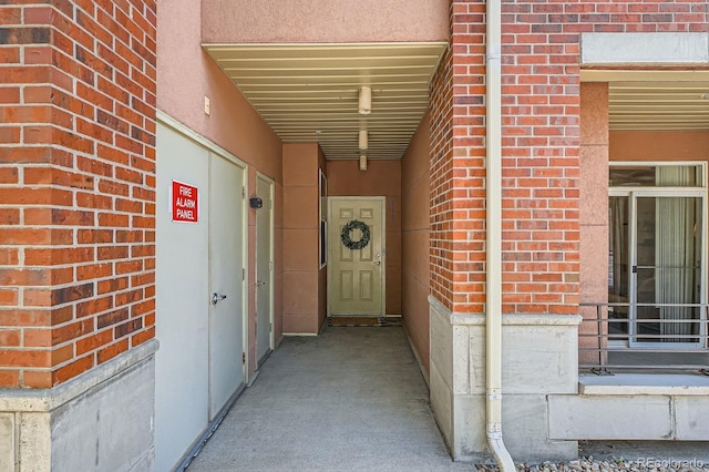 doorway to property with brick siding