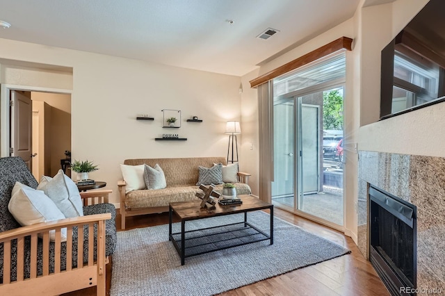 living area with wood finished floors and a fireplace