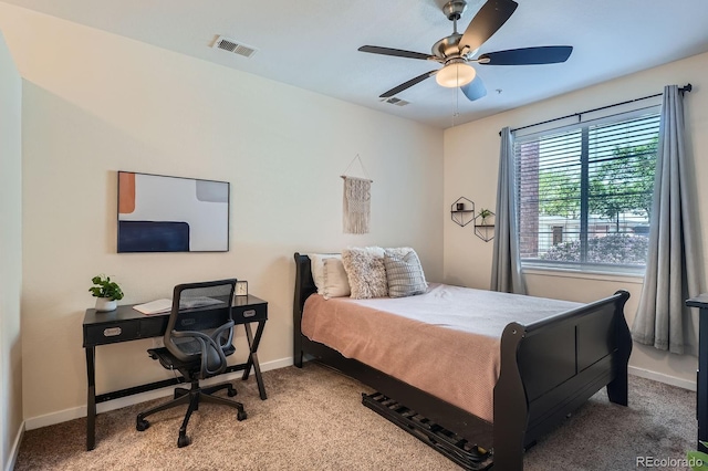 carpeted bedroom featuring baseboards, an office area, and a ceiling fan