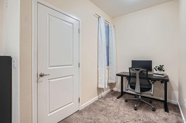 carpeted office space with baseboards