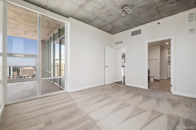 unfurnished bedroom featuring carpet and connected bathroom