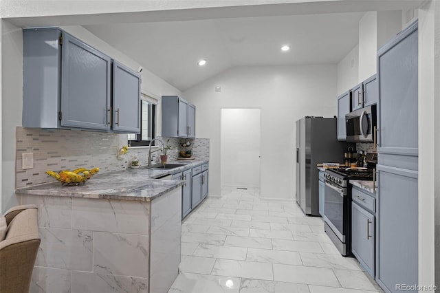 kitchen with light stone counters, a sink, marble finish floor, stainless steel appliances, and vaulted ceiling