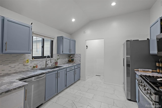 kitchen featuring a sink, marble finish floor, stainless steel appliances, decorative backsplash, and vaulted ceiling