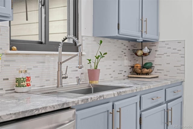 kitchen with a sink, decorative backsplash, and dishwasher