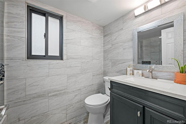 full bathroom with toilet, tile walls, tiled shower, and vanity