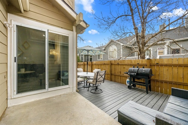 deck with fence, outdoor dining space, and area for grilling