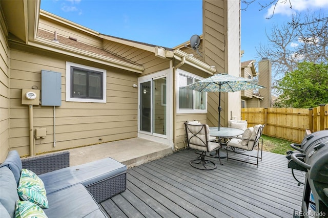 wooden deck featuring outdoor dining area, fence, and grilling area