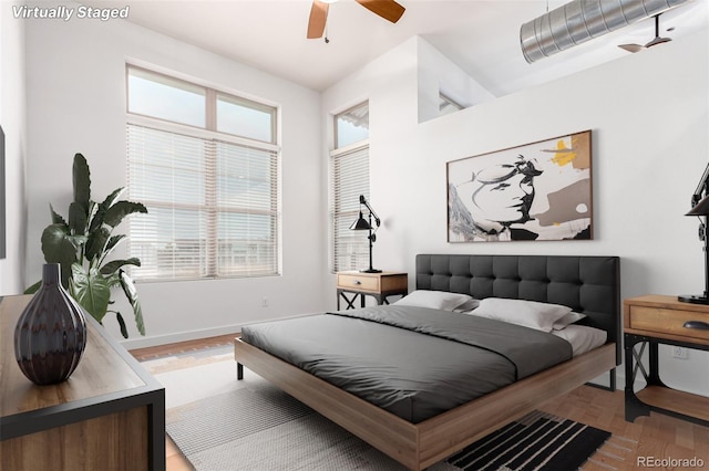 7700 E 29th Ave Unit 405, Denver, CO 80238 - bedroom with wood finished floors, baseboards, and a ceiling fan