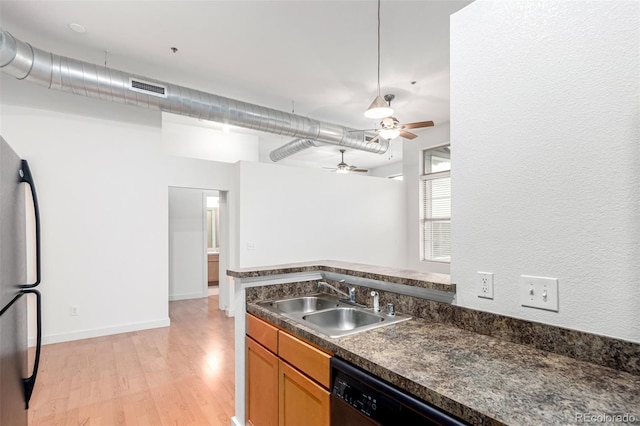 7700 E 29th Ave Unit 405, Denver, CO 80238 - kitchen with a sink, freestanding refrigerator, dark countertops, light wood-style flooring, and a ceiling fan