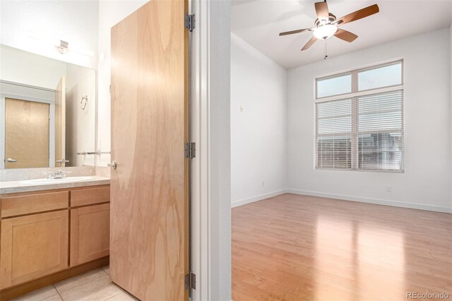 7700 E 29th Ave Unit 405, Denver, CO 80238 - bathroom with ceiling fan, wood finished floors, vanity, and baseboards