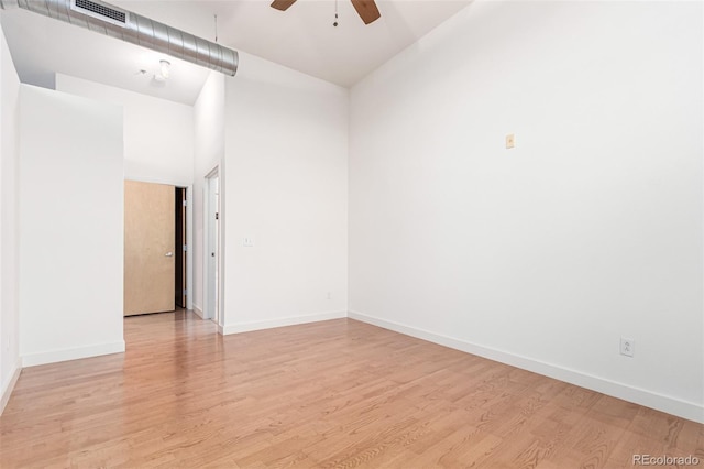 7700 E 29th Ave Unit 405, Denver, CO 80238 - empty room with a ceiling fan, light wood-style floors, baseboards, and a high ceiling