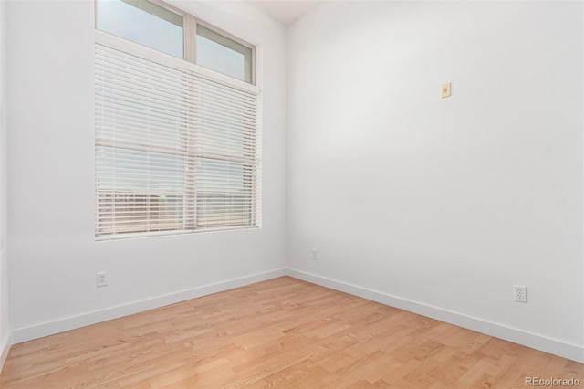 7700 E 29th Ave Unit 405, Denver, CO 80238 - unfurnished room featuring light wood-style flooring, plenty of natural light, and baseboards