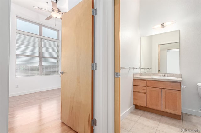 7700 E 29th Ave Unit 405, Denver, CO 80238 - bathroom with a ceiling fan, vanity, toilet, baseboards, and wood finished floors
