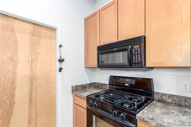 7700 E 29th Ave Unit 405, Denver, CO 80238 - kitchen with black appliances and light brown cabinetry