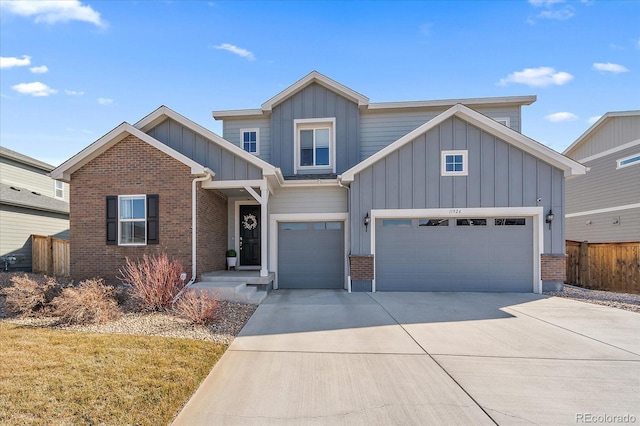 view of front of home with brick siding, fence, board and batten siding, and driveway