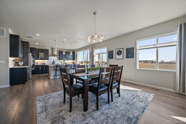 dining space with plenty of natural light, baseboards, and dark wood-style flooring