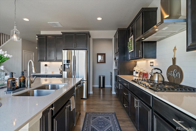 kitchen with visible vents, dark wood-type flooring, stainless steel appliances, wall chimney exhaust hood, and a sink