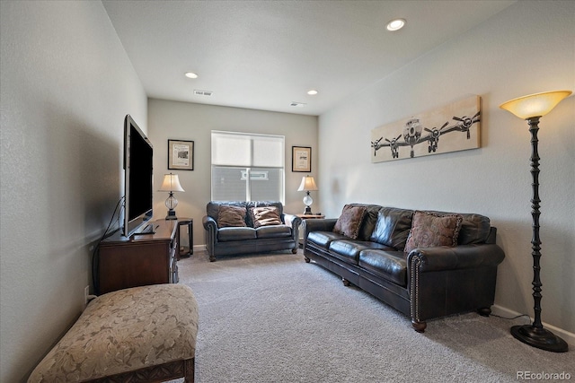 carpeted living area featuring recessed lighting, visible vents, and baseboards