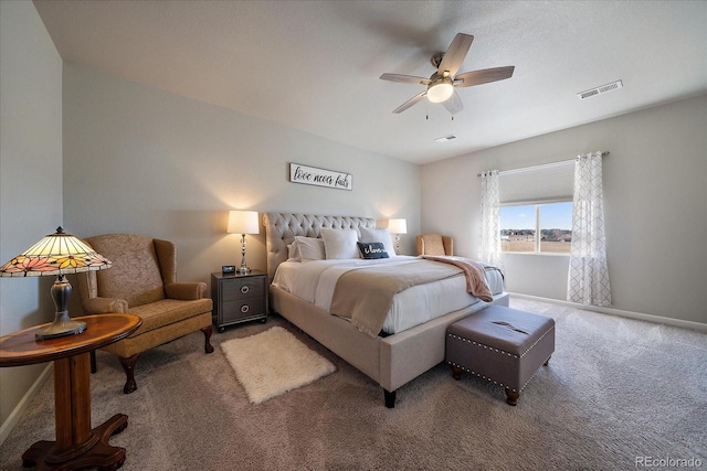 carpeted bedroom featuring visible vents, ceiling fan, and baseboards