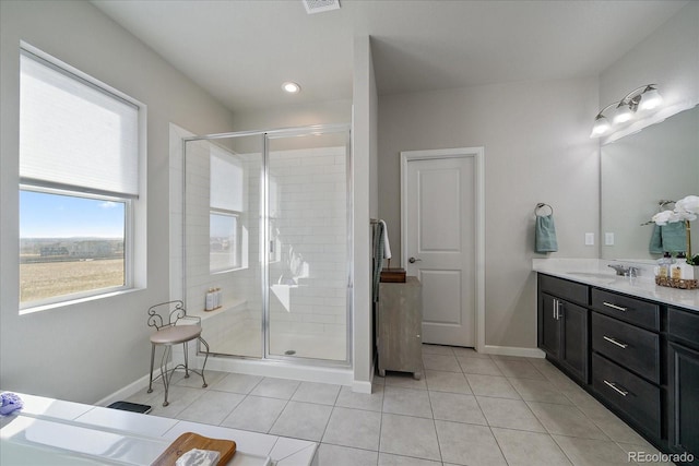 full bath with tile patterned flooring, a stall shower, vanity, and baseboards