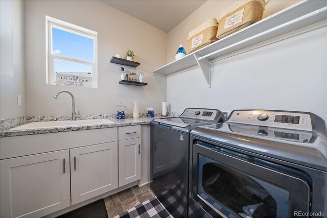 laundry area with a sink, cabinet space, and washing machine and dryer