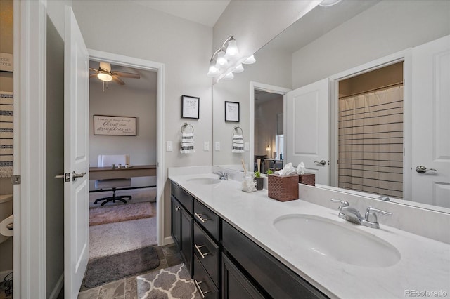 bathroom with double vanity, ceiling fan, and a sink