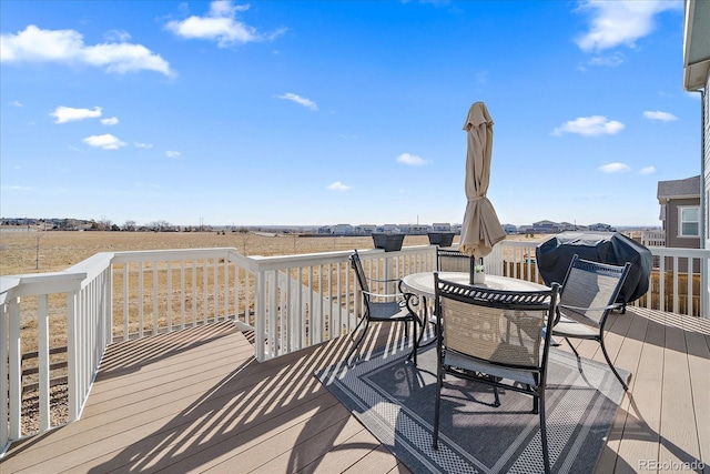 deck featuring a grill and outdoor dining area