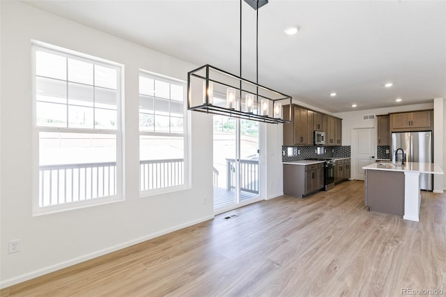 4451 Soapberry Pl, Castle Rock, CO 80108 - kitchen with stainless steel appliances, light wood-style floors, tasteful backsplash, light countertops, and recessed lighting