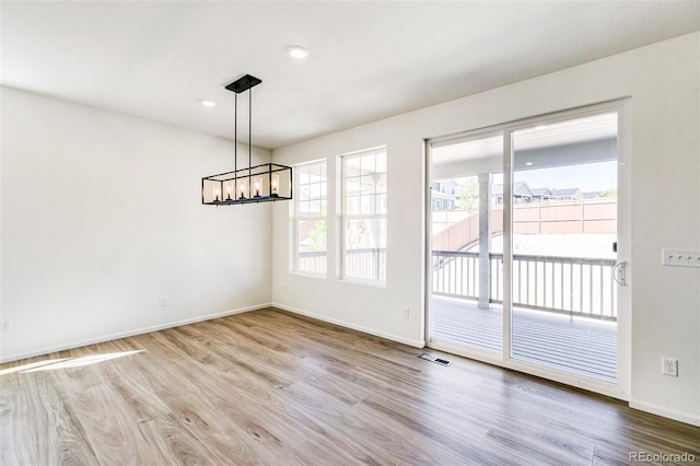 4451 Soapberry Pl, Castle Rock, CO 80108 - unfurnished dining area with a chandelier and wood finished floors
