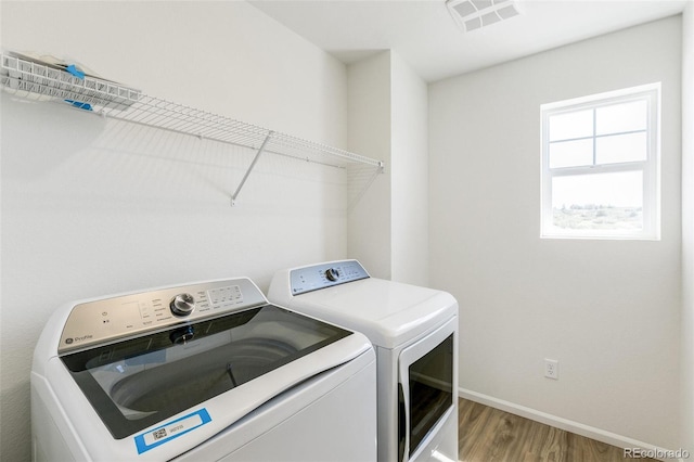 4451 Soapberry Pl, Castle Rock, CO 80108 - laundry area with washing machine and dryer and light wood finished floors
