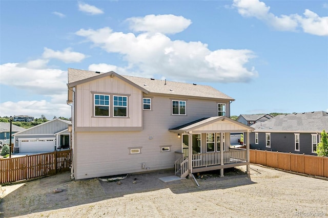 4451 Soapberry Pl, Castle Rock, CO 80108 - rear view of property with board and batten siding, a fenced backyard, and a deck