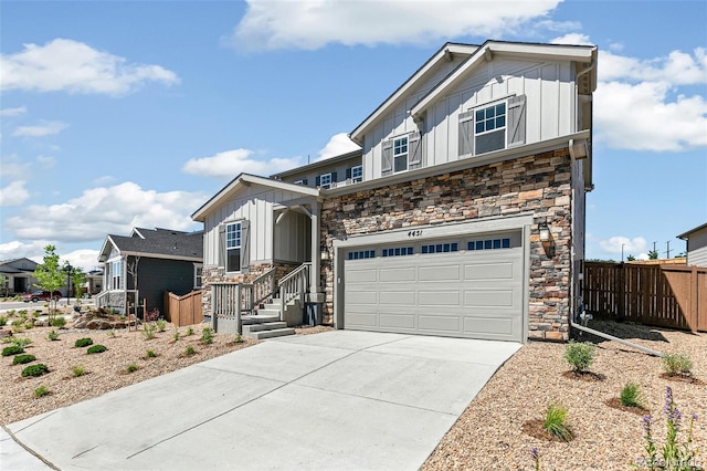 4451 Soapberry Pl, Castle Rock, CO 80108 - view of front of house with board and batten siding, stone siding, a garage, and concrete driveway
