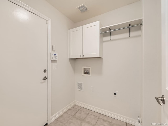 laundry area featuring cabinet space, baseboards, visible vents, hookup for a washing machine, and hookup for an electric dryer