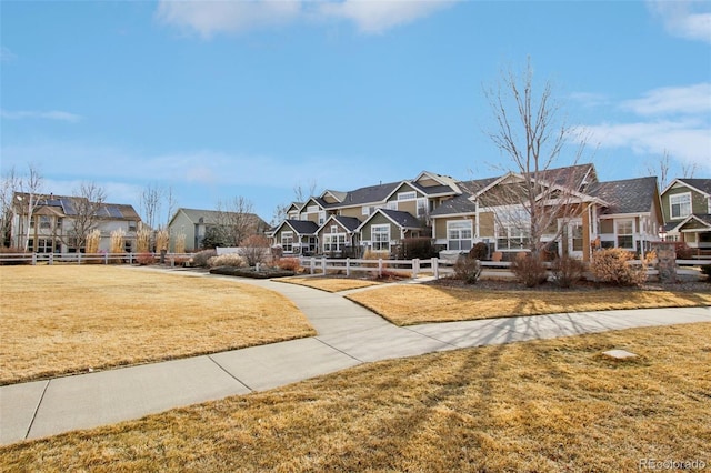 exterior space featuring a yard, a residential view, and fence