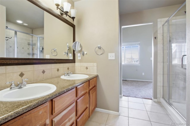 bathroom featuring a sink, tasteful backsplash, a stall shower, and tile patterned flooring