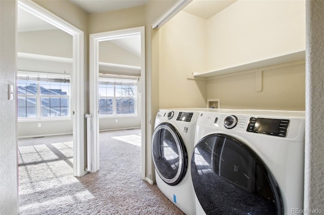 laundry room with baseboards, separate washer and dryer, carpet flooring, and laundry area