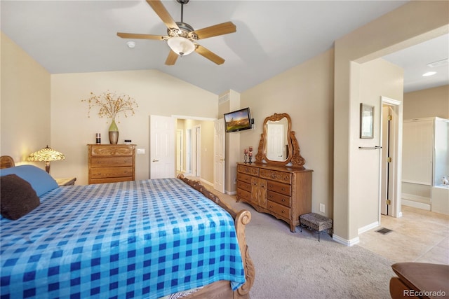 bedroom featuring ceiling fan, lofted ceiling, ensuite bathroom, and light carpet