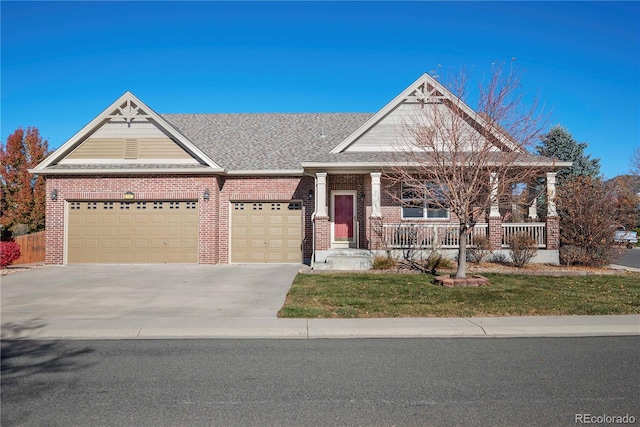 craftsman inspired home featuring a front lawn, covered porch, and a garage