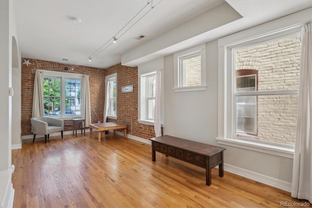 1580 N Franklin St, Denver, CO 80218 - entryway featuring brick wall, light wood-style floors, and baseboards