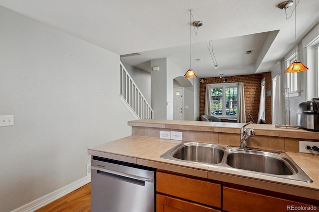 1580 N Franklin St, Denver, CO 80218 - kitchen featuring stainless steel dishwasher, a sink, light wood finished floors, and pendant lighting