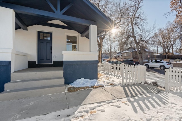 view of snow covered property entrance