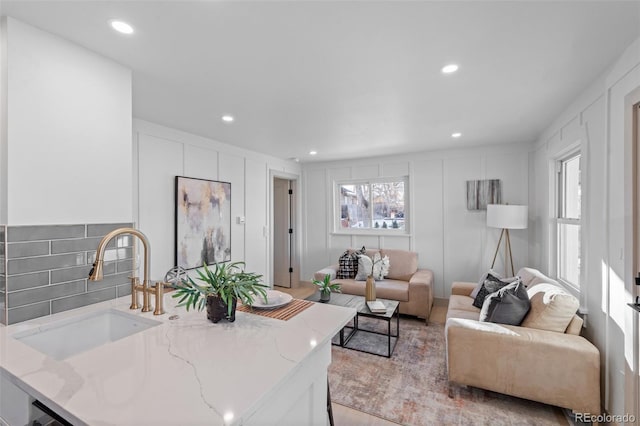 living room featuring a healthy amount of sunlight and sink