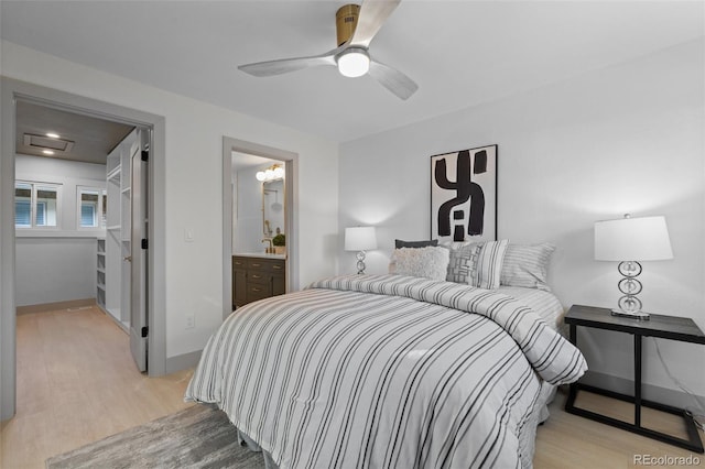 bedroom featuring ceiling fan, connected bathroom, and light hardwood / wood-style floors