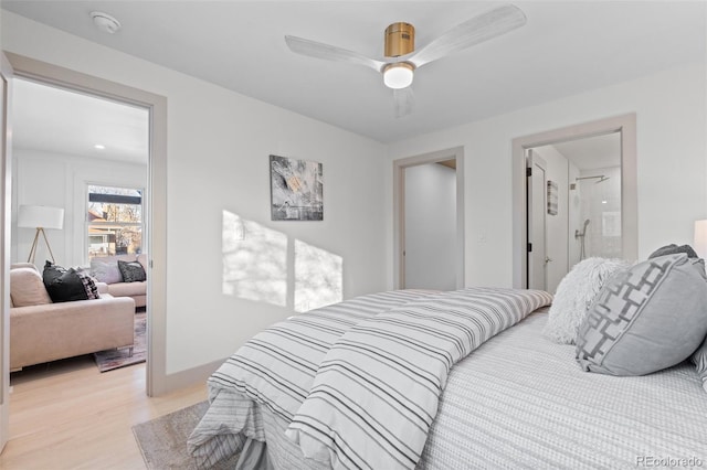 bedroom with light hardwood / wood-style flooring, ceiling fan, and ensuite bathroom