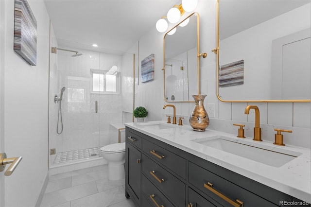 bathroom featuring a shower with door, tile walls, vanity, tile patterned floors, and toilet