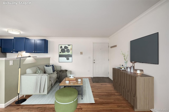 living room featuring crown molding, baseboards, and dark wood-type flooring
